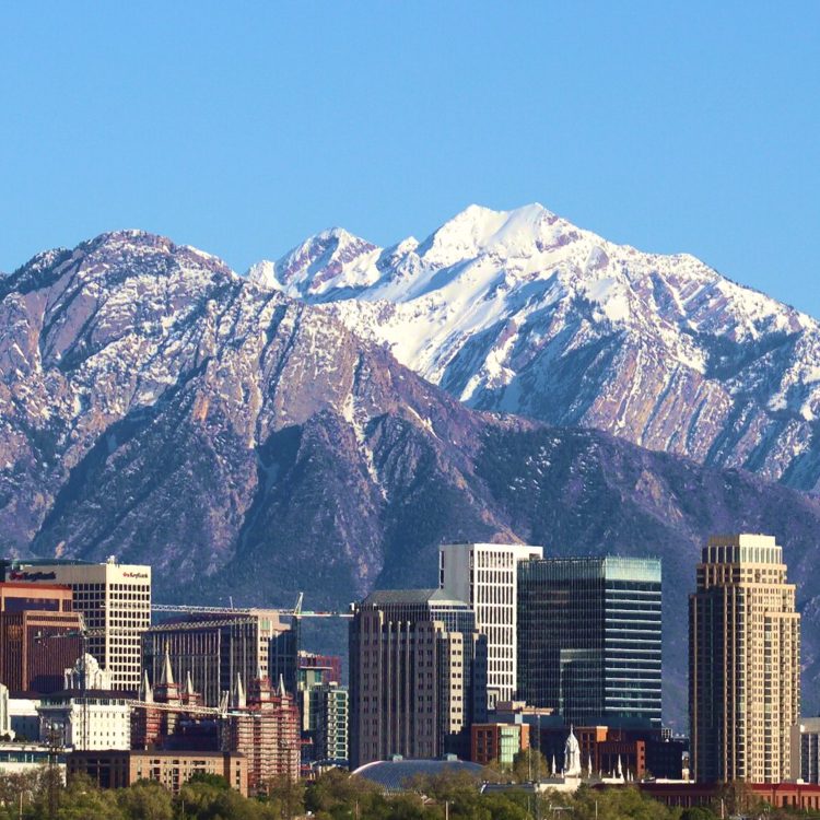 Salt Lake City skyline with snow-capped mountains in background, fulfillment and shipping hub